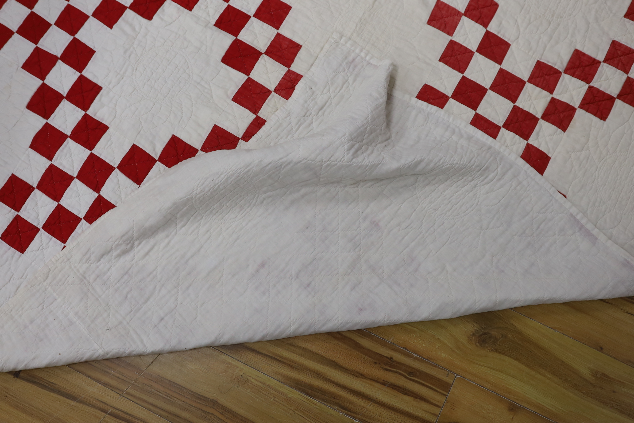 An American quilt Texas Star pattern, red on white backing